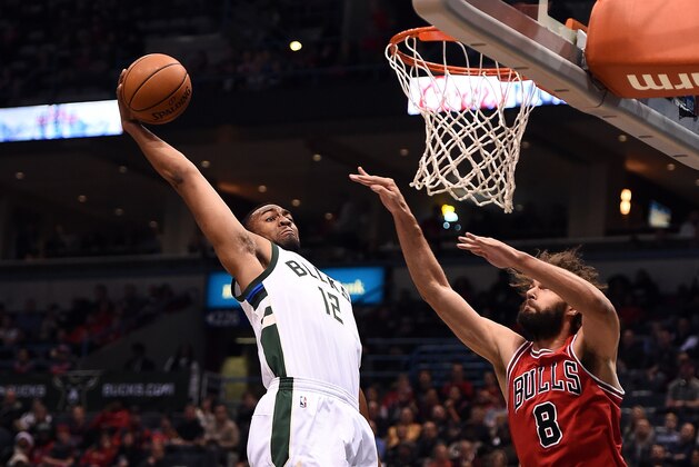 MILWAUKEE, WI - DECEMBER 15:  Jabari Parker #12 of the Milwaukee Bucks dunks against Robin Lopez #8 of the Chicago Bulls during the first half of a game at the BMO Harris Bradley Center on December 15, 2016 in Milwaukee, Wisconsin.  NOTE TO USER: User expressly acknowledges and agrees that, by downloading and or using this photograph, User is consenting to the terms and conditions of the Getty Images License Agreement.  (Photo by Stacy Revere/Getty Images)