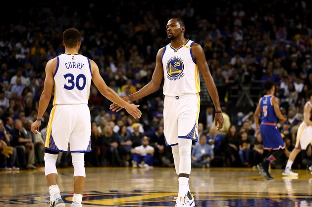 OAKLAND, CA - DECEMBER 15:  Kevin Durant #35 and Stephen Curry #30 of the Golden State Warriors high-five one another during their game against the New York Knicks at ORACLE Arena on December 15, 2016 in Oakland, California. NOTE TO USER: User expressly acknowledges and agrees that, by downloading and or using this photograph, User is consenting to the terms and conditions of the Getty Images License Agreement.  (Photo by Ezra Shaw/Getty Images)