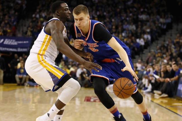 OAKLAND, CA - DECEMBER 15:  Kristaps Porzingis #6 of the New York Knicks drives on Draymond Green #23 of the Golden State Warriors at ORACLE Arena on December 15, 2016 in Oakland, California. NOTE TO USER: User expressly acknowledges and agrees that, by downloading and or using this photograph, User is consenting to the terms and conditions of the Getty Images License Agreement.  (Photo by Ezra Shaw/Getty Images)