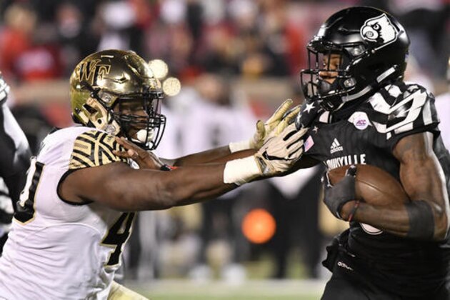 Wake Forest's Josh Banks (40) attempts to grab Louisville's Lamar Jackson (8) during the second half of an NCAA college football game Saturday, Nov. 12, 2016, in Louisville Ky. Louisville won 44-12. (AP Photo/Timothy D. Easley)