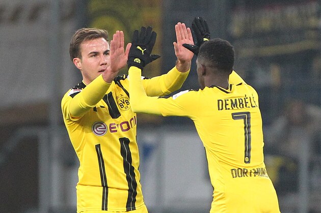 Dortmund's midfielder Mario Goetze (L) celebrates scoring the 1-1 with Dortmund's French midfielder Ousmane Dembele during the German first division Bundesliga football match between TSG Hoffenheim and BVB Borussia Dortmund at the Wirsol Rhein-Neckar-Arena in Sinsheim, southern Germany, on December 16, 2016. / AFP / Daniel ROLAND / RESTRICTIONS: DURING MATCH TIME: DFL RULES TO LIMIT THE ONLINE USAGE TO 15 PICTURES PER MATCH AND FORBID IMAGE SEQUENCES TO SIMULATE VIDEO. == RESTRICTED TO EDITORIAL USE == FOR FURTHER QUERIES PLEASE CONTACT DFL DIRECTLY AT + 49 69 650050
        (Photo credit should read DANIEL ROLAND/AFP/Getty Images)