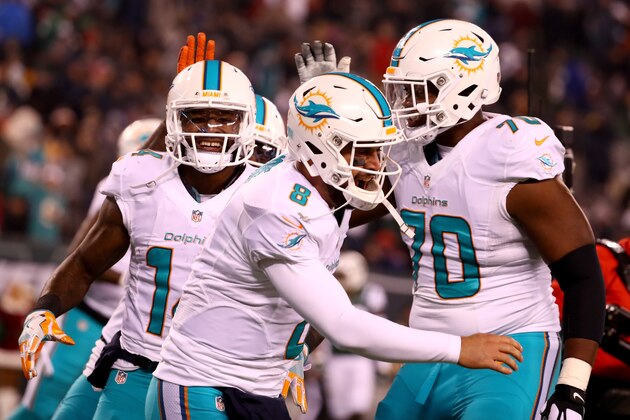 EAST RUTHERFORD, NJ - DECEMBER 17:  Matt Moore #8 of the Miami Dolphins celebrates with Jarvis Landry #14 after scoring a touchdown against the New York Jets during the third quarter of the game at MetLife Stadium on December 17, 2016 in East Rutherford, New Jersey.  (Photo by Al Bello/Getty Images)