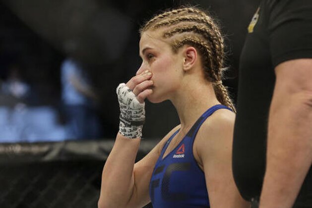 Paige VanZant reacts after losing to Michelle Waterson in a UFC Fight Night mixed martial arts fight in Sacramento, Calif., Saturday, Dec. 17, 2016. Waterson won by submission in the first round. (AP Photo/Jeff Chiu)