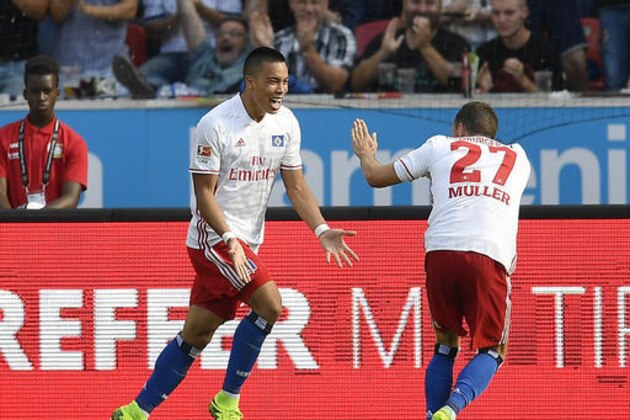 Hamburg's scorer Bobby Wood, left, celebrates his opening goal with Hamburg's Nicolai Mueller, right, during the German Bundesliga soccer match between Bayer Leverkusen and Hamburger SV in Leverkusen, Germany, Saturday, Sept. 10, 2016. (AP Photo/Martin Meissner)