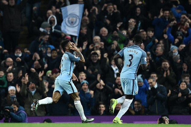 Manchester City's English midfielder Raheem Sterling (L) celebrates scoring his team's second goal during the English Premier League football match between Manchester City and Arsenal at the Etihad Stadium in Manchester, north west England, on December 18, 2016. / AFP / Oli SCARFF / RESTRICTED TO EDITORIAL USE. No use with unauthorized audio, video, data, fixture lists, club/league logos or 'live' services. Online in-match use limited to 75 images, no video emulation. No use in betting, games or single club/league/player publications.  /         (Photo credit should read OLI SCARFF/AFP/Getty Images)