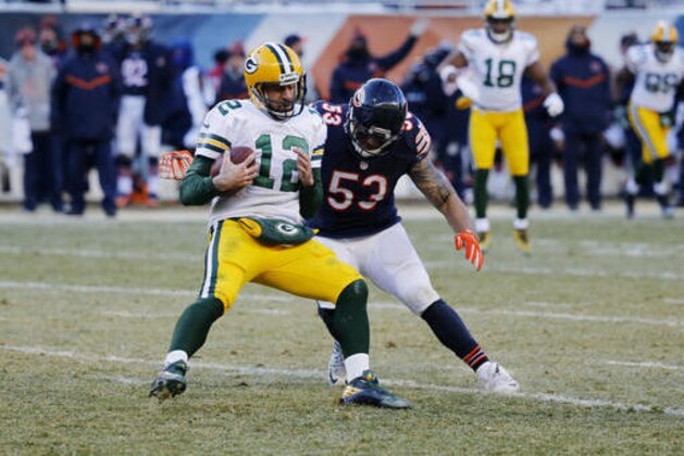 Green Bay Packers quarterback Aaron Rodgers (12) is tackled by Chicago Bears linebacker John Timu (53) during the second half of an NFL football game, Sunday, Dec. 18, 2016, in Chicago. (AP Photo/Charles Rex Arbogast)