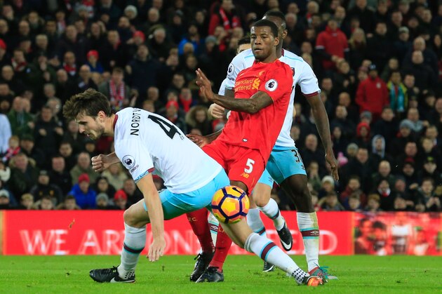 Liverpool's Dutch midfielder Georginio Wijnaldum (R) plays the ball past the defense of West Ham United's Norwegian midfielder Havard Nordtveit (L) during the English Premier League football match between Liverpool and West Ham United at Anfield in Liverpool, north west England on December 11, 2016. / AFP / Lindsey PARNABY / RESTRICTED TO EDITORIAL USE. No use with unauthorized audio, video, data, fixture lists, club/league logos or 'live' services. Online in-match use limited to 75 images, no video emulation. No use in betting, games or single club/league/player publications.  /         (Photo credit should read LINDSEY PARNABY/AFP/Getty Images)