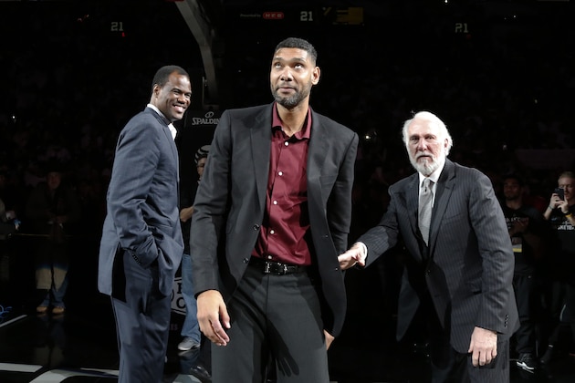 SAN ANTONIO,TX - DECEMBER 18:  Former San Antonio Spurs star Tim Duncan (C) reacts to the crowd as head coach Gregg Popovich (R) and former Spur David Robinson (L) look on while honoring the retirement of Duncan's jersey number  at AT&T Center after the game against the New Orleans Pelicans on December 18, 2016 in San Antonio, Texas.  NOTE TO USER: User expressly acknowledges and agrees that , by downloading and or using this photograph, User is consenting to the terms and conditions of the Getty Images License Agreement. (Photo by Ronald Cortes/Getty Images)