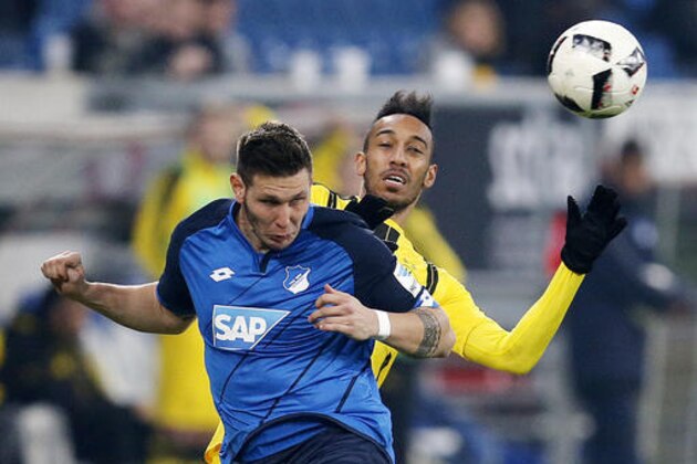Hoffenheim's Niklas Suele, left, and Dortmund's Pierre-Emerick Aubameyang challenge for the ball during a German first division Bundesliga soccer match between TSG 1899 Hoffenheim and Borussia Dortmund in Sinsheim, Germany, Friday, Dec. 16, 2016.(AP Photo/Michael Probst)