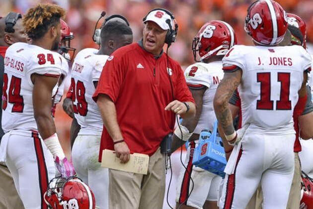 FILE - In this Oct. 15, 2016, file photo, North Carolina State head coach Dave Doeren reacts during the second half of an NCAA college football game against Clemson in Clemson, S.C. The Wolfpack lost eight turnovers during a three-game losing streak entering Saturday’s visit from No. 19 Florida State. Reversing this sudden trend is critical for a team struggling to find its footing ever since a crushing loss at Clemson on Oct. 15. (AP Photo/Richard Shiro, File)