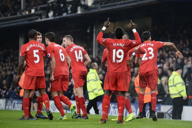 Liverpool's Senegalese midfielder Sadio Mane celebrates scoring his team's first goal during the English Premier League football match between Everton and Liverpool at Goodison Park in Liverpool, north west England on December 19, 2016. / AFP / Oli SCARFF / RESTRICTED TO EDITORIAL USE. No use with unauthorized audio, video, data, fixture lists, club/league logos or 'live' services. Online in-match use limited to 75 images, no video emulation. No use in betting, games or single club/league/player publications.  /         (Photo credit should read OLI SCARFF/AFP/Getty Images)