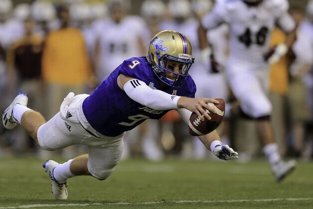 MIAMI, FL - DECEMBER 19: Dane Evans #9 of the Tulsa Golden Hurricane reaches for extra yardage during the game against the Tulsa Golden Hurricane at Marlins Park on December 19, 2016 in Miami, Florida. (Photo by Rob Foldy/Getty Images)