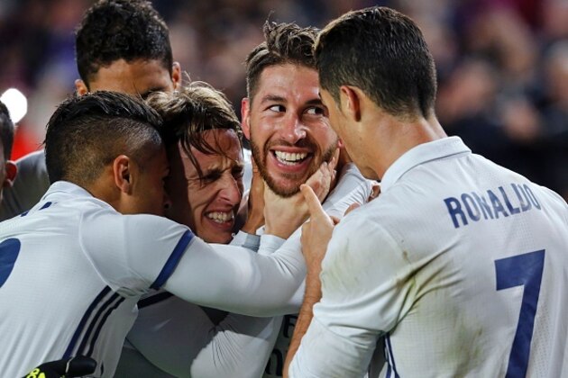 Real Madrid's defender Sergio Ramos (2ndR) celebrates with Real Madrid's Croatian midfielder Luka Modric (2ndL) and teammates after scoring the equalizer during the Spanish league football match FC Barcelona vs Real Madrid CF at the Camp Nou stadium in Barcelona on December 3, 2016. / AFP / PAU BARRENA        (Photo credit should read PAU BARRENA/AFP/Getty Images)