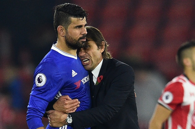 Chelsea's Italian head coach Antonio Conte (2nd L) embraces Chelsea's Brazilian-born Spanish striker Diego Costa (L) after the English Premier League football match between Southampton and Chelsea at St Mary's Stadium in Southampton, southern England on October 30, 2016.
Chelsea won the game 2-0. / AFP / GLYN KIRK / RESTRICTED TO EDITORIAL USE. No use with unauthorized audio, video, data, fixture lists, club/league logos or 'live' services. Online in-match use limited to 75 images, no video emulation. No use in betting, games or single club/league/player publications.  /         (Photo credit should read GLYN KIRK/AFP/Getty Images)