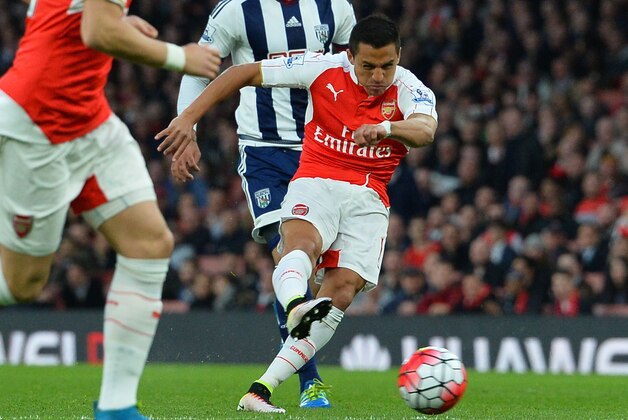Arsenal's Chilean striker Alexis Sanchez scores the opening goal during the English Premier League football match between Arsenal and West Bromwich Albion at the Emirates Stadium in London on April 21, 2016.  / AFP / GLYN KIRK / RESTRICTED TO EDITORIAL USE. No use with unauthorized audio, video, data, fixture lists, club/league logos or 'live' services. Online in-match use limited to 75 images, no video emulation. No use in betting, games or single club/league/player publications.  /         (Photo credit should read GLYN KIRK/AFP/Getty Images)