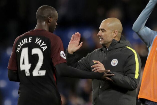 Manchester City's Yaya Toure, who scored both their goals, celebrates with his head coach Pep Guardiola after the English Premier League soccer match between Crystal Palace and Manchester City at Selhurst Park stadium in London, Saturday, Nov. 19, 2016. (AP Photo/Matt Dunham)