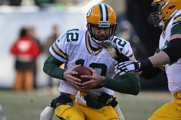 CHICAGO, IL - DECEMBER 18:  Aaron Rodgers #12 of the Green Bay Packers is sacked by Pernell McPhee #92 of the Chicago Bears in the fourth quarter at Soldier Field on December 18, 2016 in Chicago, Illinois. The Packers defeated the Bears 30-27.  (Photo by Jonathan Daniel/Getty Images)