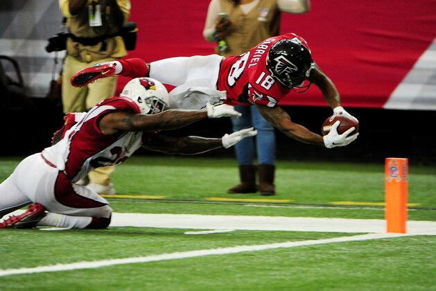 ATLANTA, GA - NOVEMBER 27: Taylor Gabriel #18 of the Atlanta Falcons dives for the pylon past Tony Jefferson #22 of the Arizona Cardinals to score a touchdown during the second half at the Georgia Dome on November 27, 2016 in Atlanta, Georgia. (Photo by Scott Cunningham/Getty Images)