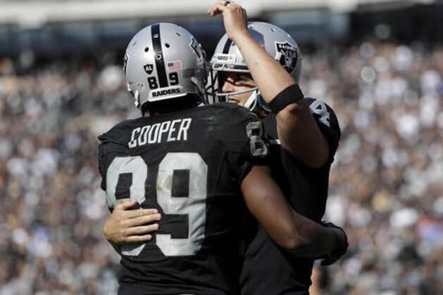 Oakland Raiders wide receiver Amari Cooper (89) and quarterback Derek Carr celebrate after connecting on a touchdown pass against the San Diego Chargers during the second half of an NFL football game in Oakland, Calif., Sunday, Oct. 9, 2016. (AP Photo/Marcio Jose Sanchez)