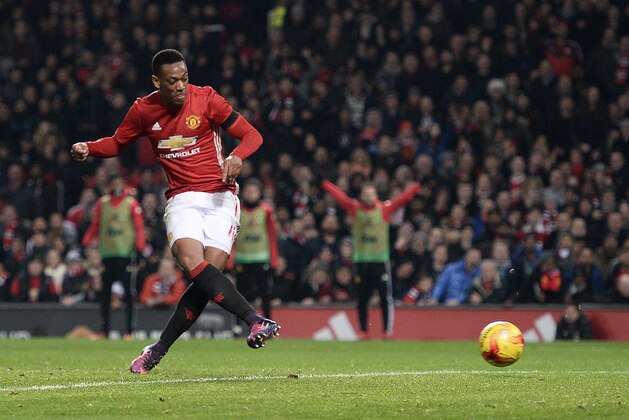 Manchester United's French striker Anthony Martial scores his team's thrid goal during the EFL (English Football League) Cup quarter-final football match between Manchester United and West Ham United at Old Trafford in Manchester, north west England, on November 30, 2016. / AFP / Oli SCARFF / RESTRICTED TO EDITORIAL USE. No use with unauthorized audio, video, data, fixture lists, club/league logos or 'live' services. Online in-match use limited to 75 images, no video emulation. No use in betting, games or single club/league/player publications.  /         (Photo credit should read OLI SCARFF/AFP/Getty Images)