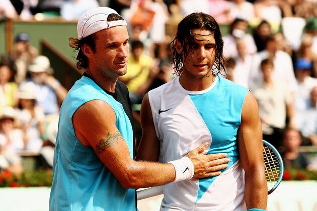 PARIS - JUNE 06:  Rafael Nadal (R) of Spain shakes hands after beating Carlos Moya (L) of Spain during the Men's Singles Quarter Final match on day eleven of the French Open at Roland Garros on June 6, 2007 in Paris, France.  (Photo by Clive Brunskill/Getty Images)