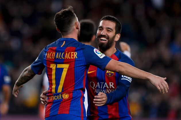 Barcelona's forward Paco Alcacer (L) is congratulated by his teammate Barcelona's Turkish midfielder Arda Turan after scoring during the Spanish Copa del Rey (King's Cup) round of 32 second leg football match FC Barcelona vs Hercules CF at the Camp Nou stadium in Barcelona on December 21, 2016. / AFP / JOSEP LAGO        (Photo credit should read JOSEP LAGO/AFP/Getty Images)