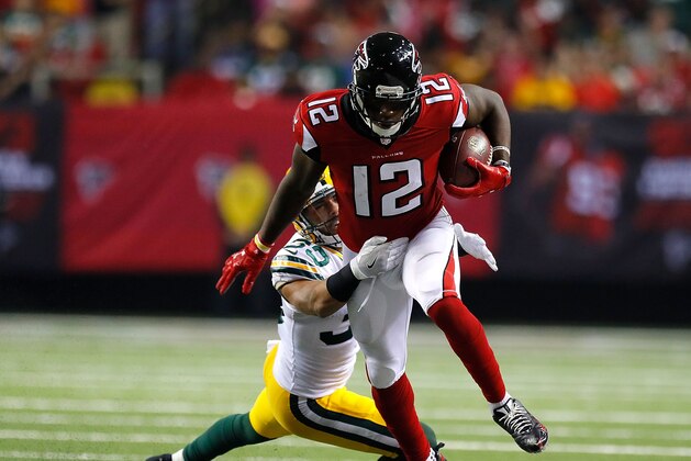 ATLANTA, GA - OCTOBER 30:  Mohamed Sanu #12 of the Atlanta Falcons attempts to break a tackle by Micah Hyde #33 of the Green Bay Packers at Georgia Dome on October 30, 2016 in Atlanta, Georgia.  (Photo by Kevin C. Cox/Getty Images)