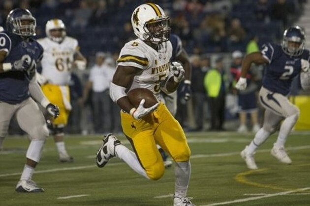 Wyoming running back Brian Hill runs for a touchdown in the second half of an NCAA college football game against Nevada on Saturday, Oct. 22, 2016 in Reno, Nev. (AP Photo/Tom R. Smedes)