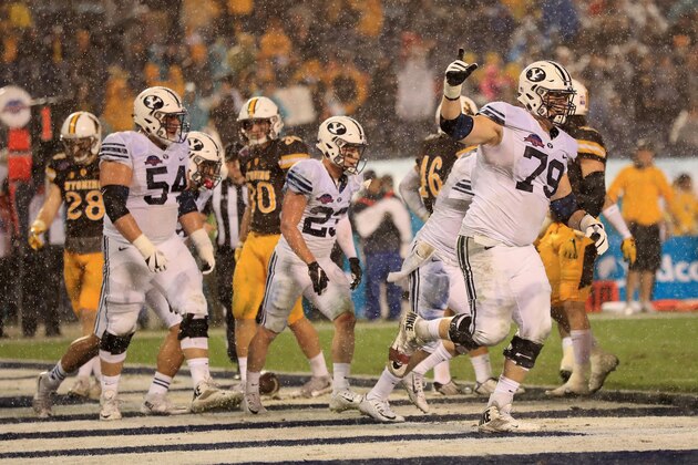 SAN DIEGO, CA - DECEMBER 21:  Andrew Eide #79 and Parker Dawe #54 of the Brigham Young Cougars celebrate a rushing touchdown during the first half of  the Poinsettia Bowl at Qualcomm Stadium on December 21, 2016 in San Diego, California.  (Photo by Sean M. Haffey/Getty Images)