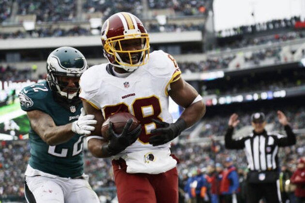 FILE - In this Dec. 11, 2016 file photo, Washington Redskins' Pierre Garcon, right, scores a touchdown past Philadelphia Eagles' Nolan Carroll during the second half of an NFL football game in Philadelphia. The veteran wide receiver Garcon hasn’t missed a game in four seasons and is as sure a bet to catch the ball as he is to be in the lineup. Garcon has 64 catches without a drop this season, providing the consistency to go along with DeSean Jackson’s speed and sizzle in Washington’s passing attack. (AP Photo/Michael Perez, File)