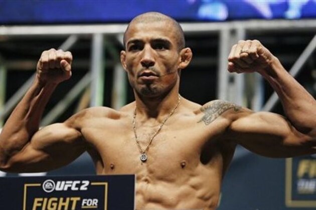 Jose Aldo poses on the scale during the weigh-in for UFC 194, Friday, Dec. 11, 2015, in Las Vegas. Aldo is scheduled to fight Conor McGregor in a featherweight championship bout Saturday in Las Vegas. (AP Photo/John Locher)