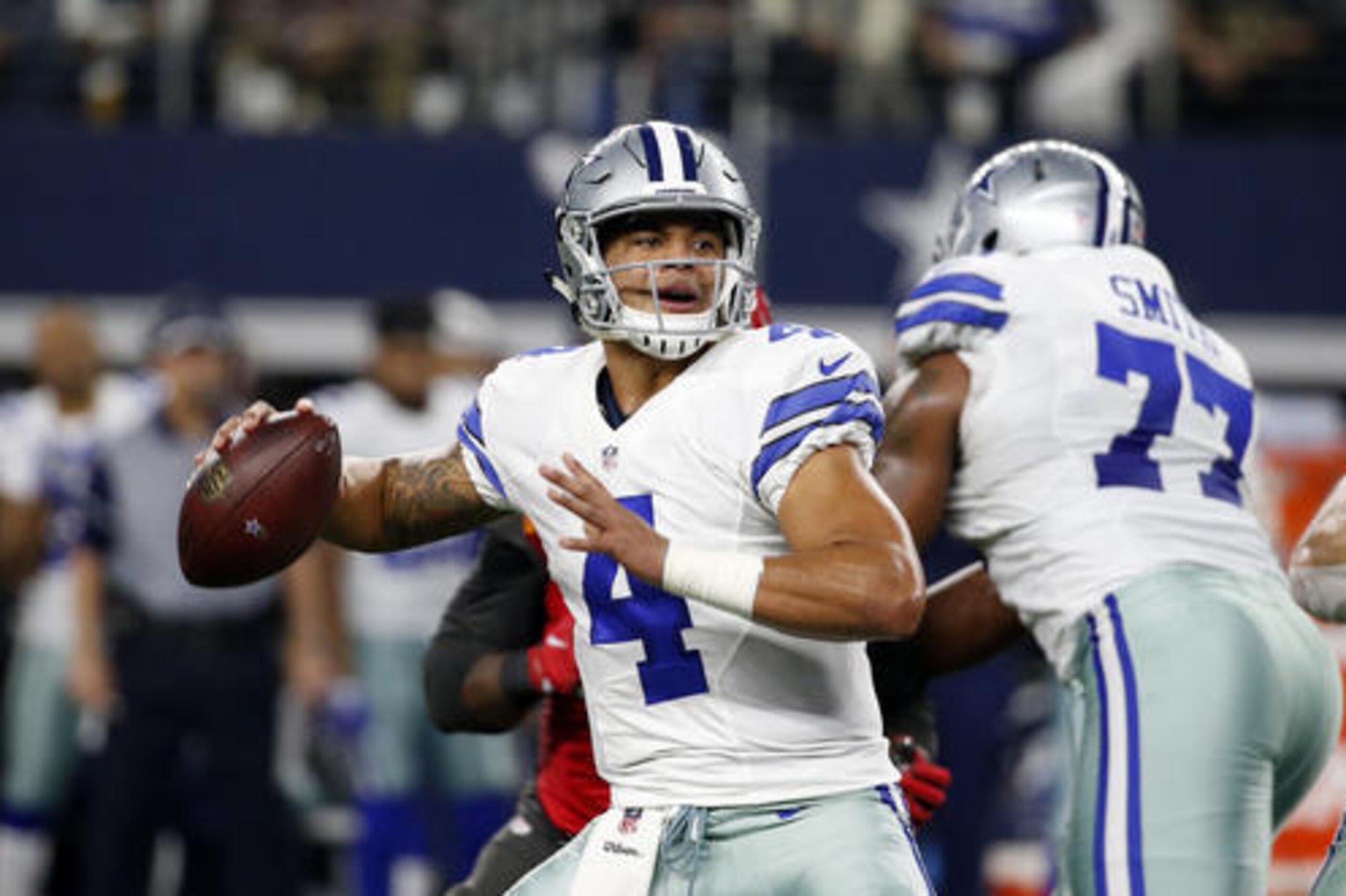 Dallas Cowboys quarterback Dak Prescott (4) prepares to throw a pass as Tyron Smith (77) provides protection in the first half of an NFL football game against the Tampa Bay Buccaneers on Sunday, Dec. 18, 2016, in Arlington, Texas. (AP Photo/Michael Ainsworth) Dallas Cowboys quarterback Dak Prescott (4) prepares to throw a pass as Tyron Smith (77) provides protection in the first half of an NFL football game against the Tampa Bay Buccaneers on Sunday, Dec. 18, 2016, in Arlington, Texas. (AP Photo/Michael Ainsworth)