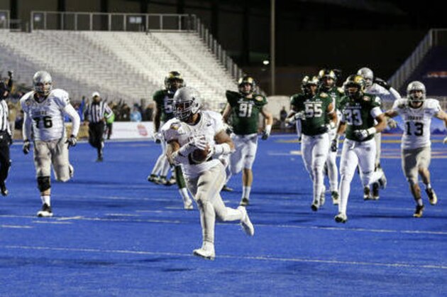 Idaho running back Isaiah Saunders (21) runs for a touchdown during the first half of the Famous Idaho Potato Bowl NCAA college football game against Colorado State in Boise, Idaho, Thursday, Dec. 22, 2016. (AP Photo/Otto Kitsinger)