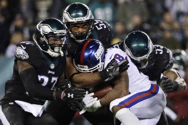 Philadelphia Eagles' Malcolm Jenkins (27), Brandon Graham (55) and Nigel Bradham (53) tackle New York Giants' Paul Perkins (28) during the second half of an NFL football game, Thursday, Dec. 22, 2016, in Philadelphia. (AP Photo/Matt Rourke)
