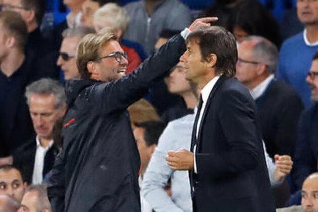 Liverpool's head coach Juergen Klopp, left, and Chelsea's team manager Antonio Conte stand on the sidelines in the last minutes of the English Premier League soccer match between Chelsea and Liverpool at Stamford Bridge stadium in London, Friday, Sept. 16, 2016. (AP Photo/Frank Augstein)