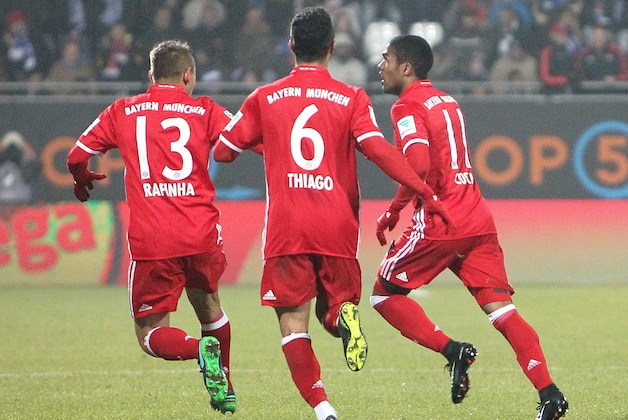 Bayern Munich's Brazilian midfielder Douglas Costa (R) celebrates scoring the opening goal with Bayern Munich's Spanish midfielder Thiago Alcantara (C) and Bayern Munich's Brazilian defender Rafinha during the German first division Bundesliga football match SV Darmstadt 98 vs FC Bayern Munich in Darmstadt, Germany, on December 18, 2016. / AFP / Amelie QUERFURTH / RESTRICTIONS: DURING MATCH TIME: DFL RULES TO LIMIT THE ONLINE USAGE TO 15 PICTURES PER MATCH AND FORBID IMAGE SEQUENCES TO SIMULATE VIDEO. == RESTRICTED TO EDITORIAL USE == FOR FURTHER QUERIES PLEASE CONTACT DFL DIRECTLY AT + 49 69 650050
        (Photo credit should read AMELIE QUERFURTH/AFP/Getty Images)