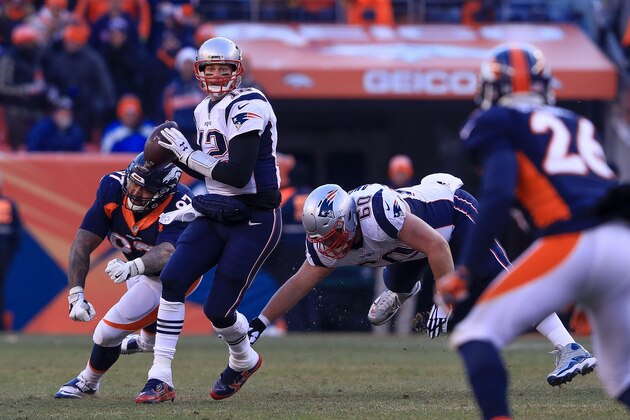 DENVER, CO - DECEMBER 18:  Quarterback Tom Brady #12 of the New England Patriots looks down the field for a receiver under pressure by defensive end Billy Winn #97 of the Denver Broncos in the first half at Sports Authority Field at Mile High on December 18, 2016 in Denver, Colorado. (Photo by Sean M. Haffey/Getty Images)