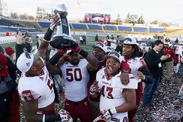 ANNAPOLIS, MD - DECEMBER 03:  Members of the Temple Owls celebrate with the trophy after defeating the Navy Midshipmen 34-10 win the AAC Championship game at Navy-Marine Corps Memorial Stadium on December 3, 2016 in Annapolis, Maryland.  (Photo by Rob Carr/Getty Images)