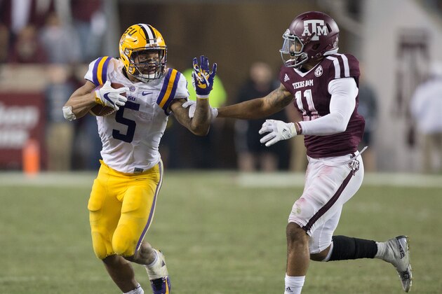 COLLEGE STATION, TX - NOVEMBER 24: Derrius Guice #5 of the LSU Tigers fends off Larry Pryor #11 of the Texas A&M Aggies Derrius Guiceat Kyle Field on November 24, 2016 in College Station, Texas.  (Photo by Bob Levey/Getty Images)
