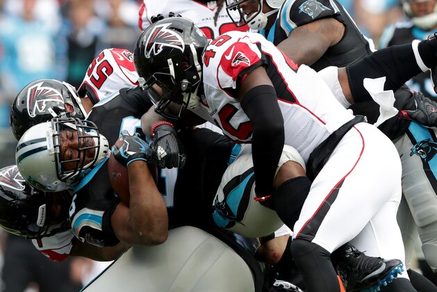 CHARLOTTE, NC - DECEMBER 24:  Jonathan Stewart #28 of the Carolina Panthers runs the ball against  Deion Jones #45 of the Atlanta Falcons in the 2nd quarter during their game at Bank of America Stadium on December 24, 2016 in Charlotte, North Carolina.  (Photo by Streeter Lecka/Getty Images)