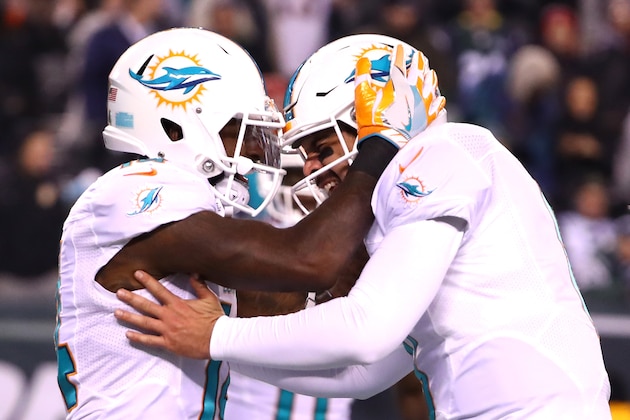 EAST RUTHERFORD, NJ - DECEMBER 17:  Matt Moore #8 of the Miami Dolphins celebrates with Jarvis Landry #14 after scoring a touchdown against the New York Jets during the third quarter of the game at MetLife Stadium on December 17, 2016 in East Rutherford, New Jersey.  (Photo by Al Bello/Getty Images)