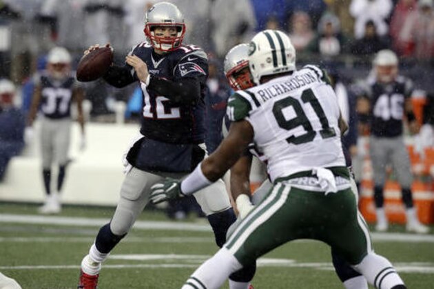 New England Patriots quarterback Tom Brady (12) passes under pressure from New York Jets defensive end Sheldon Richardson (91) during the first half of an NFL football game, Saturday, Dec. 24, 2016, in Foxborough, Mass. (AP Photo/Charles Krupa)