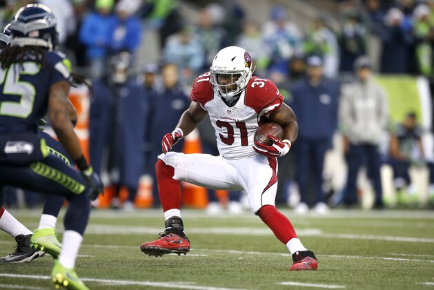 SEATTLE, WA - DECEMBER 24: Running back David Johnson #31 of the Arizona Cardinals rushes against the Seattle Seahawks at CenturyLink Field on December 24, 2016 in Seattle, Washington. (Photo by Otto Greule Jr/Getty Images)