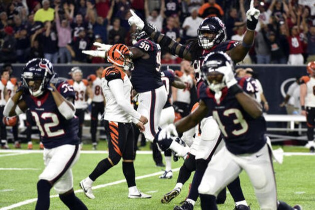 Houston Texans players celebrate after Cincinnati Bengals kicker Randy Bullock, center left, missed a field goal as time expired in an NFL football game Saturday, Dec. 24, 2016, in Houston. The Texans won 12-10. (AP Photo/Eric Christian Smith)