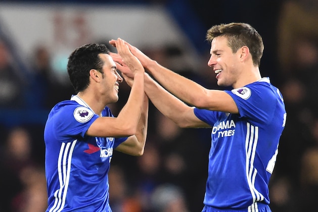 Chelsea's Spanish midfielder Pedro (L) celebrates scoring their third goal with Chelsea's Spanish defender Cesar Azpilicueta (R) during the English Premier League football match between Chelsea and Bournemouth at Stamford Bridge in London on December 26, 2016. / AFP / Glyn KIRK / RESTRICTED TO EDITORIAL USE. No use with unauthorized audio, video, data, fixture lists, club/league logos or 'live' services. Online in-match use limited to 75 images, no video emulation. No use in betting, games or single club/league/player publications.  /         (Photo credit should read GLYN KIRK/AFP/Getty Images)
