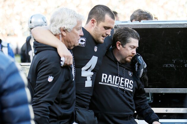 OAKLAND, CA - DECEMBER 24:  Derek Carr #4 of the Oakland Raiders is helped off the field after injuring his right leg during their NFL game against the Indianapolis Colts at Oakland Alameda Coliseum on December 24, 2016 in Oakland, California.  (Photo by Brian Bahr/Getty Images)