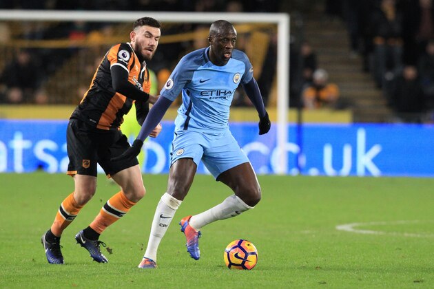 Hull City's Scottish midfielder Robert Snodgrass (L) vies with Manchester City's Ivorian midfielder Yaya Toure during the English Premier League football match between Hull City and Manchester City at the KCOM Stadium in Kingston upon Hull, north east England on December 26, 2016. / AFP / Lindsey PARNABY / RESTRICTED TO EDITORIAL USE. No use with unauthorized audio, video, data, fixture lists, club/league logos or 'live' services. Online in-match use limited to 75 images, no video emulation. No use in betting, games or single club/league/player publications.  /         (Photo credit should read LINDSEY PARNABY/AFP/Getty Images)