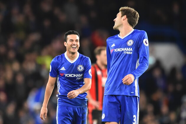 Chelsea's Spanish midfielder Pedro (L) celebrates scoring their third goal during the English Premier League football match between Chelsea and Bournemouth at Stamford Bridge in London on December 26, 2016. / AFP / Glyn KIRK / RESTRICTED TO EDITORIAL USE. No use with unauthorized audio, video, data, fixture lists, club/league logos or 'live' services. Online in-match use limited to 75 images, no video emulation. No use in betting, games or single club/league/player publications.  /         (Photo credit should read GLYN KIRK/AFP/Getty Images)