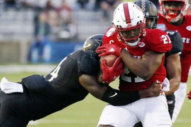 North Carolina State running back Matthew Dayes (21) tries to fight off a tackle by Vanderbilt safety Ryan White (14) in the first half of the Camping World Independence Bowl NCAA college football game in Shreveport, La., Monday, Dec. 26, 2016. (AP Photo/Rogelio V. Solis)