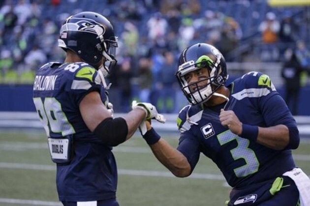 Seattle Seahawks quarterback Russell Wilson, right, and Doug Baldwin feign boxing as they warm-up before an NFL football game against the Arizona Cardinals, Saturday, Dec. 24, 2016, in Seattle. (AP Photo/Ted S. Warren)